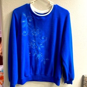 Alfred Dunner ladies blue long sleeved fleece pullover with patterned front. PM.